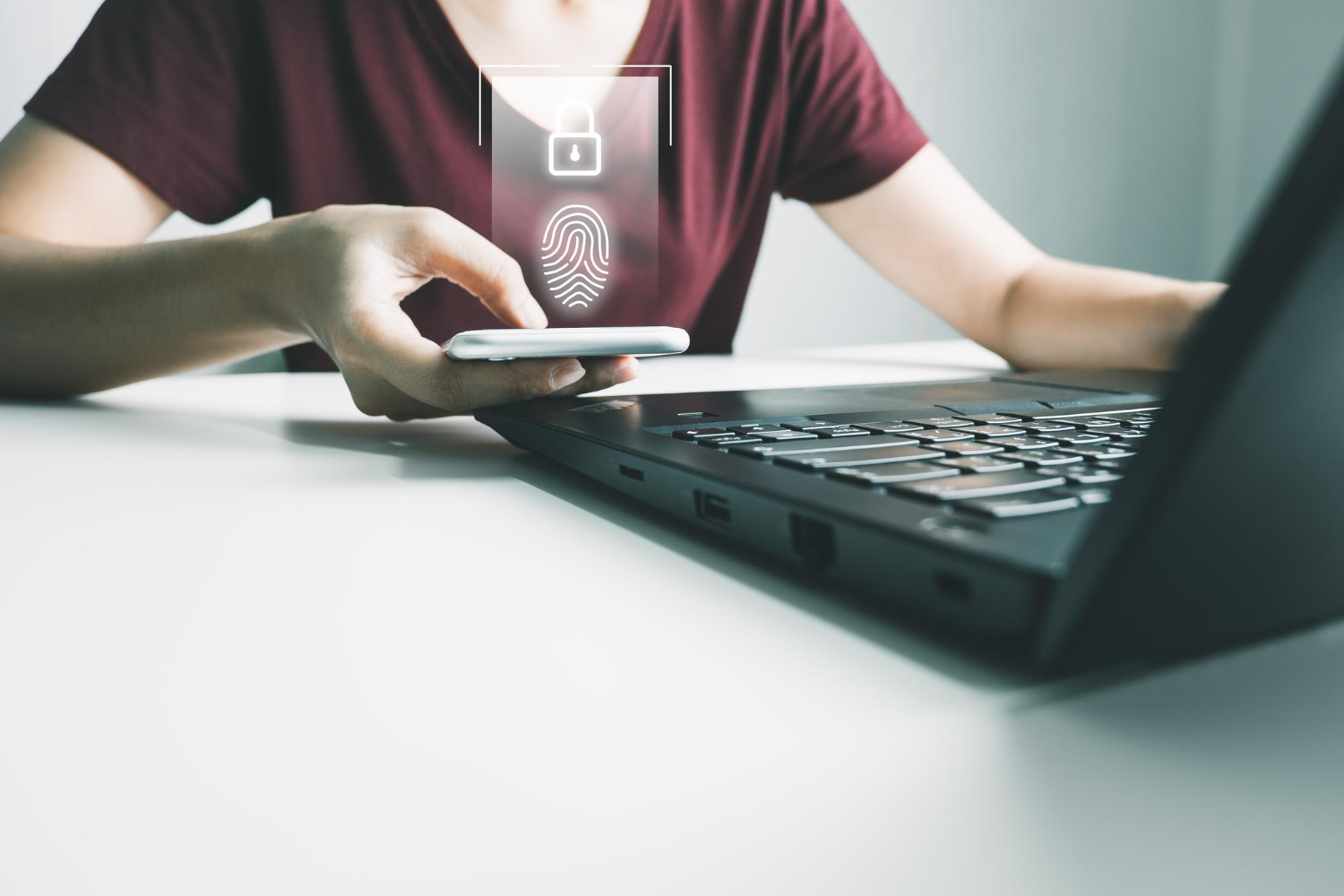 girl uses phone and laptop